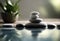 Perfectly stacked white spa stones set with water reflections