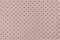 Perforated beige leather texture background, closeup. Light brown backdrop from wrinkle skin