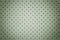 Perforated light green leather texture background, closeup. Olive backdrop from wrinkle skin