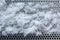 Perforated metal covered with snow