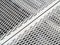 Perforated metal sheet stamping plates texture angled view. Made through metal stamping sheet metal manufacturing lightweight