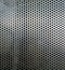 Perforated metallic grid, industrial background. Steel plate with holes