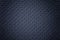 Perforated navy blue leather texture background, closeup. Denim backdrop from wrinkle skin