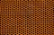 Perforated rusty iron sheet texture. Surface of industrial mesh. Horizontal corrosion steel. Top view