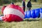 Performances on paragliding.Paragliders lie on the ground against the backdrop of paragliders