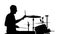 Performer plays professional music on drums. White background. Silhouettes. Side view. Slow motion