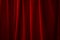 Performing arts stage and presenting a show concept with red velvet curtains with ambient light that casts strong dramatic shadow