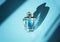 Perfume bottle on light blue background