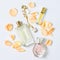 Perfume bottles with flowers petals on white background. Perfumery, cosmetics, jewelry and fragrance collection