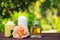 Perfume, candles and flowers on a blurred green background. Spa concept. Romantic concept.