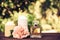 Perfume, candles and flowers on a blurred green background. Spa concept. Romantic concept.