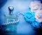 Perfume and flowers in blue tone