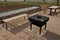 Pergola, garden pavilion is equipped with a metal grill. public barbecue place in the park. wooden camping tables. lawn around the