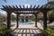 pergola and gazebo over pool surrounded by lounge chairs