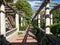 Pergola, a raised walkway, overgrown with vines.