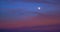 Perigee Moon Supermoon surrounded by purple clouds at sunset with a dark blue sky