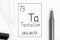 The Periodic table of elements. Handwriting chemical element Tantalum Ta with black pen, test tube and pipette