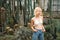 Perky beautiful female model posing playfully among succulents