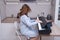 A perky cheerful musician plays the piano while sitting at a musical instrument at home in the kitchen