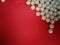 Perls or beads on red background