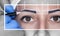 Permanent make-up for eyebrows of beautiful woman with thick brows in beauty salon. Closeup beautician doing tattooing eyebrow