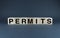 Permits. The cubes form the word Permits
