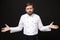 Perplexed bewildered young bearded male chef cook or baker man in white uniform shirt posing isolated on black