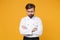 Perplexed confused young bearded male chef cook or baker man in white uniform shirt posing isolated on yellow background