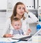 Perplexed woman with child is having problems while working