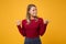 Perplexed young blonde woman girl in casual clothes posing isolated on yellow orange background studio portrait. People