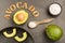 Persea americana - Avocado with sea salt. Title in wooden letters. Organic