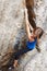 Perseverance is everything. A rock climber climbing up a cliff face.