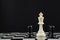 Perseverance in the face of a challenge, a conceptual image of a lonely white coloured king standing on a chessboard surrounded by