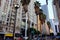 Pershing Square. Tall office buildings and palm trees next to the road shortly from