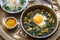 Persian breakfast with eggs, bean and dill in copper pan