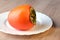Persimmon fruit, close ripe fruits on a plate