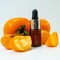 Persimmon fruit oil on a white background. Ripe persimmon fruits and extract in a cosmetic bottle with a dropper.