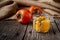 Persimmon jam or marmalade in glass jar on wooden background - close up photography