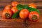 Persimmon kaki fruits on wooden table