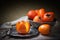 Persimmons in a pewter bowl. Still life