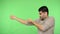 Persistent brunette man in shirt with rolled up sleeves pulling virtual rope. green background, chroma key