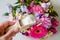 Person adding baking soda powder inside cut flowers vase so cut flowers last longer fresh.