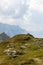 Person alone in the Alps between huge Mountain Chains inside beautiful Nature. Summer Day Panorama. Julian Alps, Triglav National