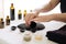 person, applying warm towel and essential oils for relaxing hot stone massage