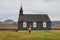 Person on background of Famous black church of Budir at Snaefellsnes peninsula