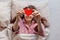 person in bed holds heart-shaped postcard in hands. surprise Valentine's day greeting from lover
