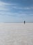 person in black jacket standing on vast desert field at daytime