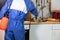 Person in a blue costume and an anti-gas mask doing a sanitary inspection in the kitchen