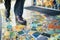 person in business attire stepping onto an office mosaic entry