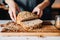 person buttering multigrain bread